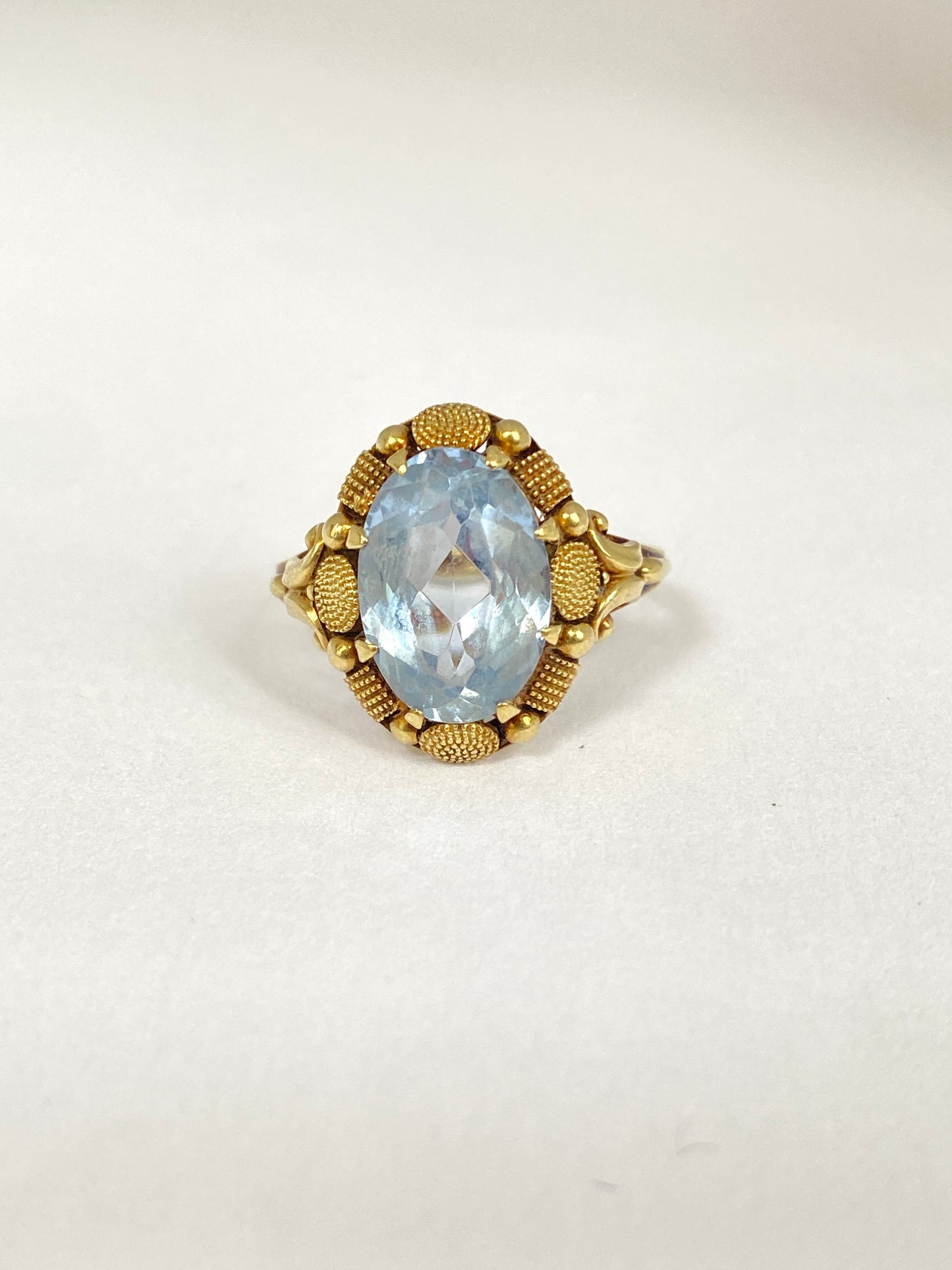 Continental, 14ct Gold Blue Topaz Ring with incredible border