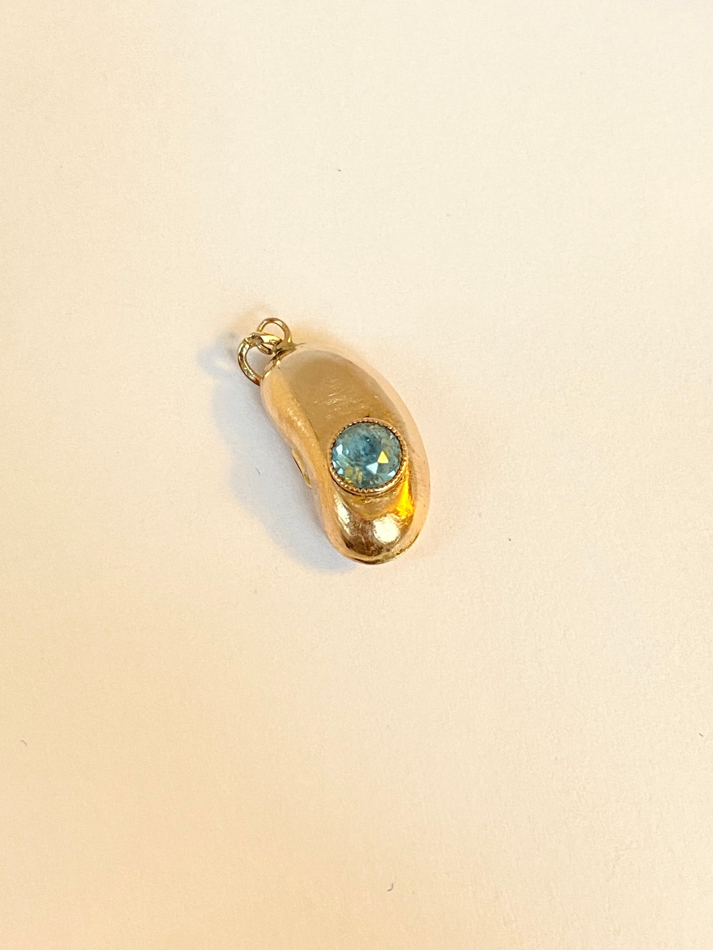 9ct Gold, Antique, Kidney Bean Lucky Charm, with bezel set Aquamarine