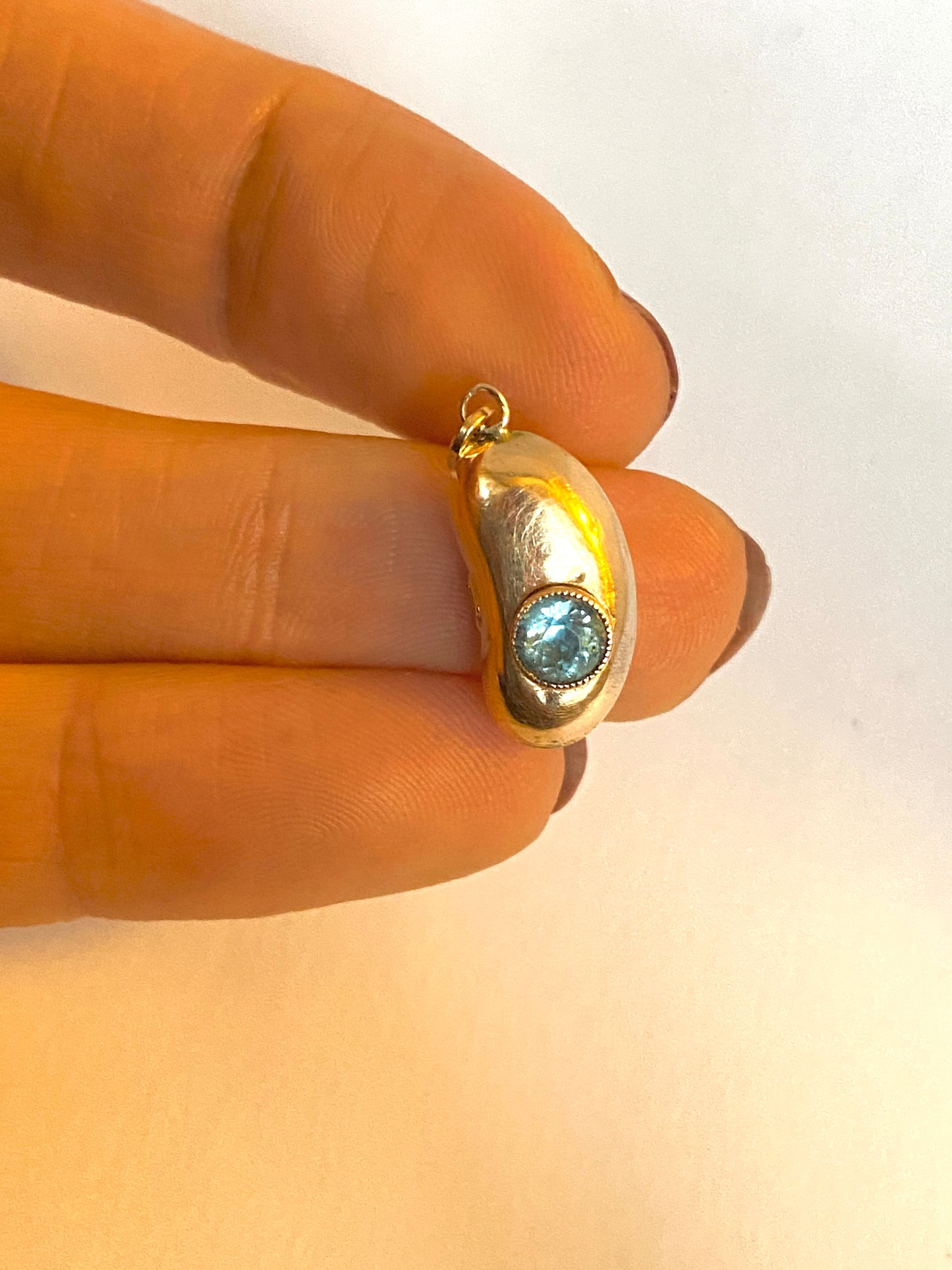 9ct Gold, Antique, Kidney Bean Lucky Charm, with bezel set Aquamarine